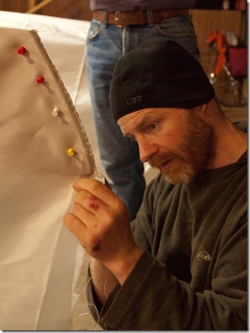 Finishing the stern.  We sewed just about an inch along the top so that we could hook this back over the end of the boat when tensioning